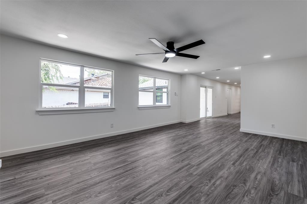 11341 Gatewood Place Dallas, TX 75218 - Photo 18 of 29 a view of an empty room with a window and wooden floor
