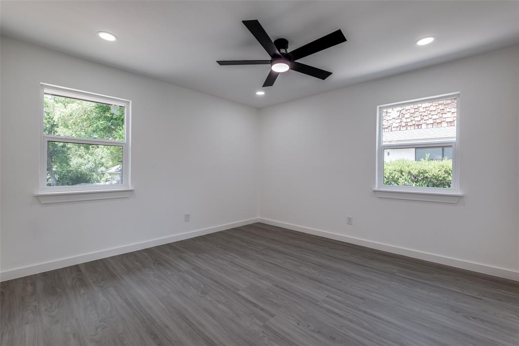 11341 Gatewood Place Dallas, TX 75218 - Photo 22 of 29 an empty room with wooden floor and windows