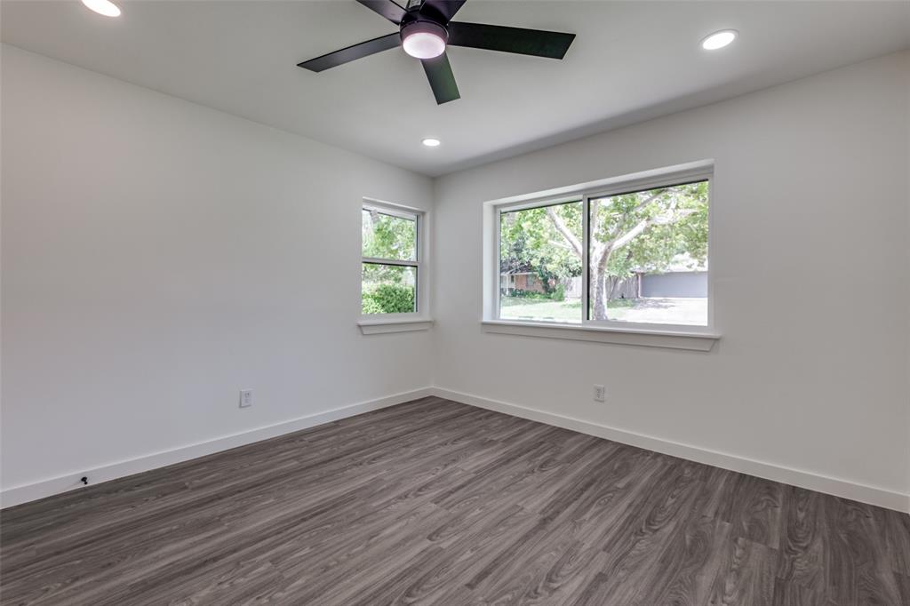 11341 Gatewood Place Dallas, TX 75218 - Photo 25 of 29 a view of a room with wooden floor and windows