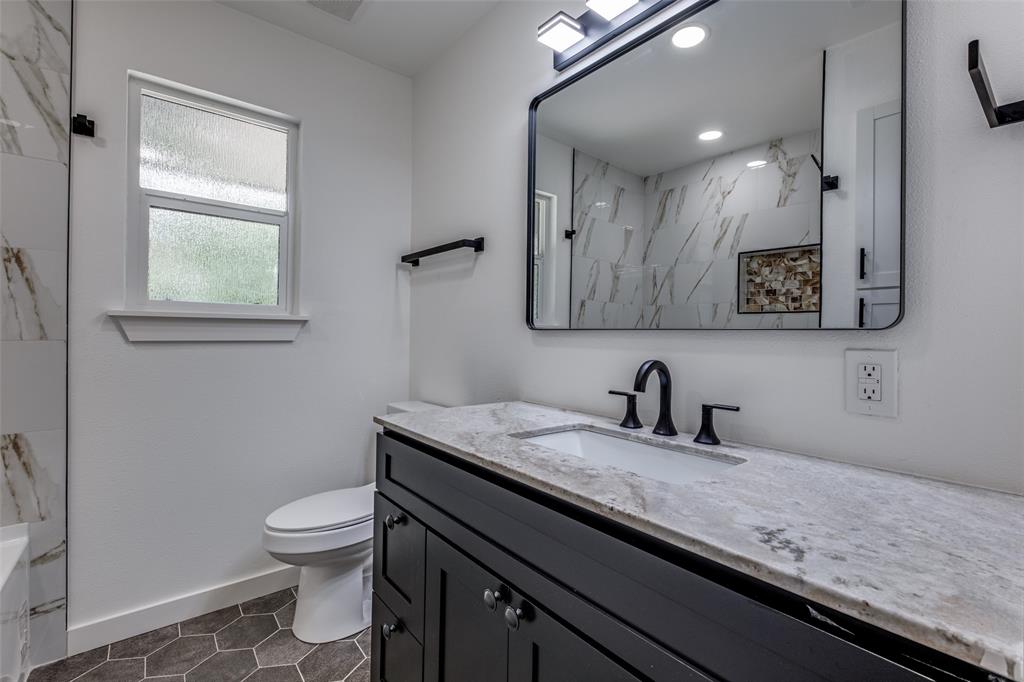 11341 Gatewood Place Dallas, TX 75218 - Photo 26 of 29 a bathroom with a granite countertop sink a toilet and mirror
