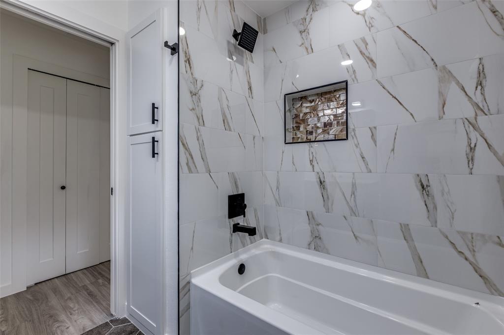 11341 Gatewood Place Dallas, TX 75218 - Photo 27 of 29 a bathroom with a bathtub and a shower