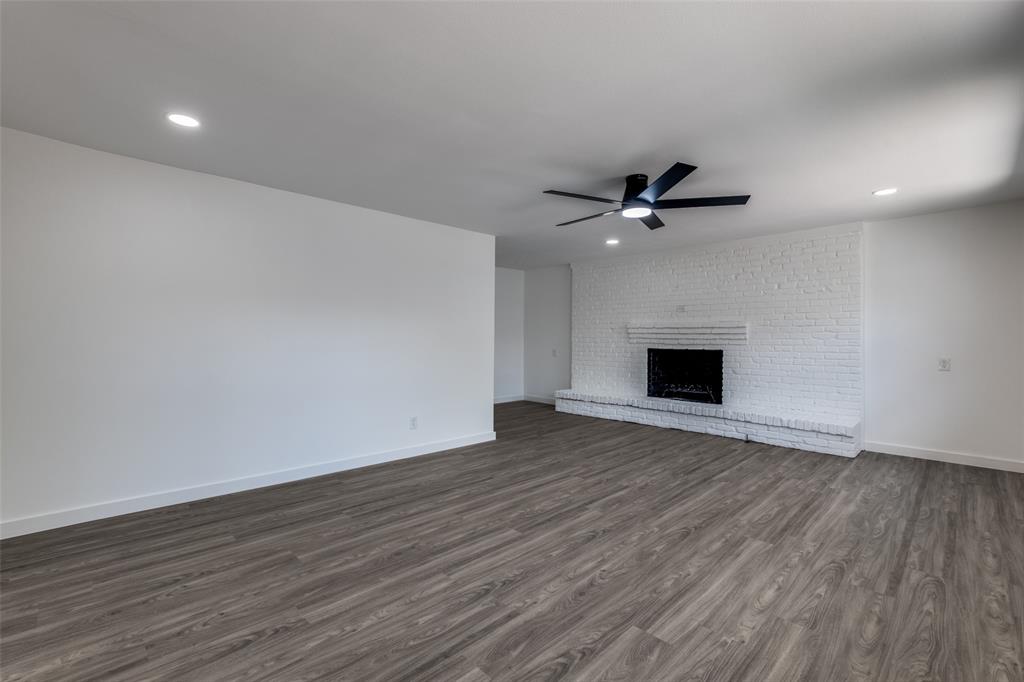 11341 Gatewood Place Dallas, TX 75218 - Photo 8 of 29 a view of an empty room with wooden floor and a ceiling fan