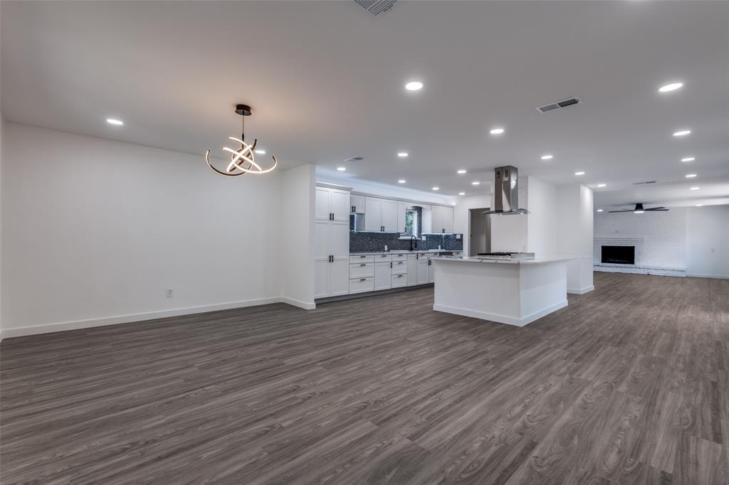 11341 Gatewood Place Dallas, TX 75218 - Photo 10 of 29 a view of kitchen with kitchen island a sink wooden floor and a refrigerator