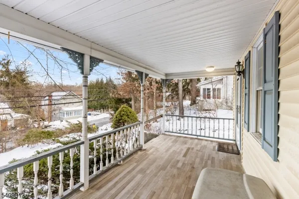a view of a porch with wooden floor