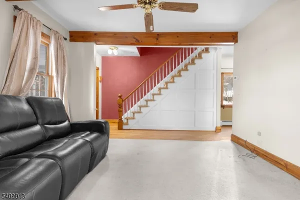 a living room with furniture and stairs