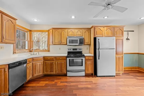 a kitchen with a refrigerator a sink and a stove