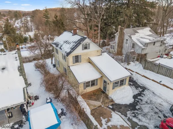 an aerial view of a house with a mountain