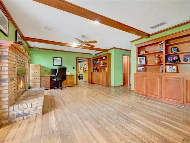a view of a livingroom with furniture workspace and a window