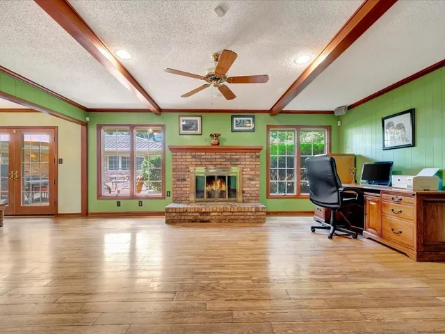 a living room with furniture fireplace and window