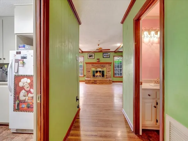 a view of hallway with wooden floor