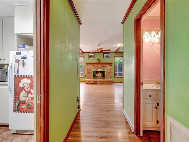 a view of hallway with wooden floor