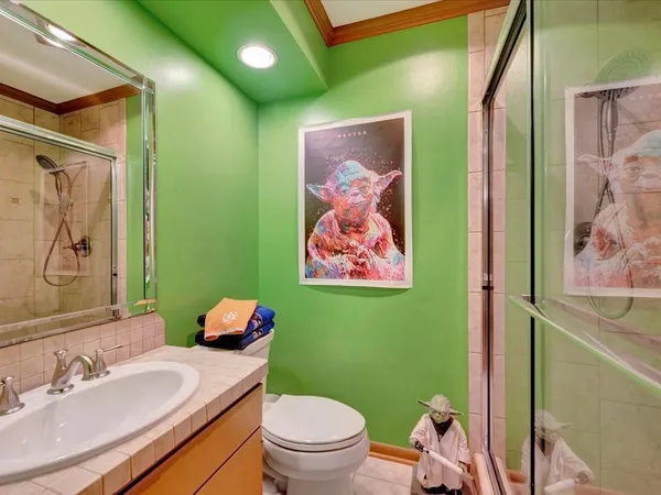 a bathroom with a toilet sink and mirror
