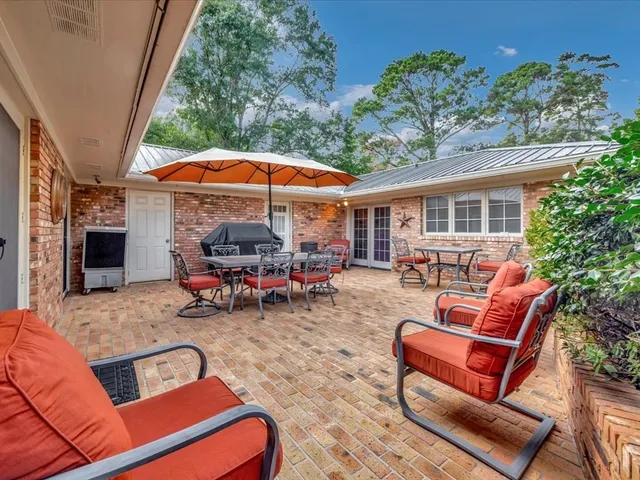 a view of a backyard with a patio and outdoor seating