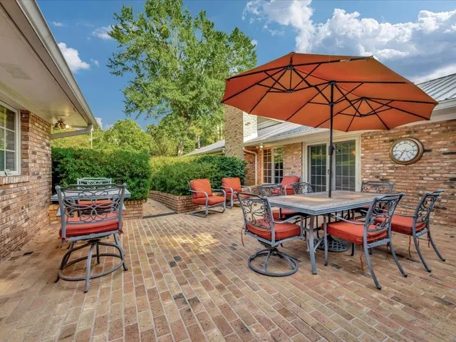 an outdoor space with furniture and umbrella