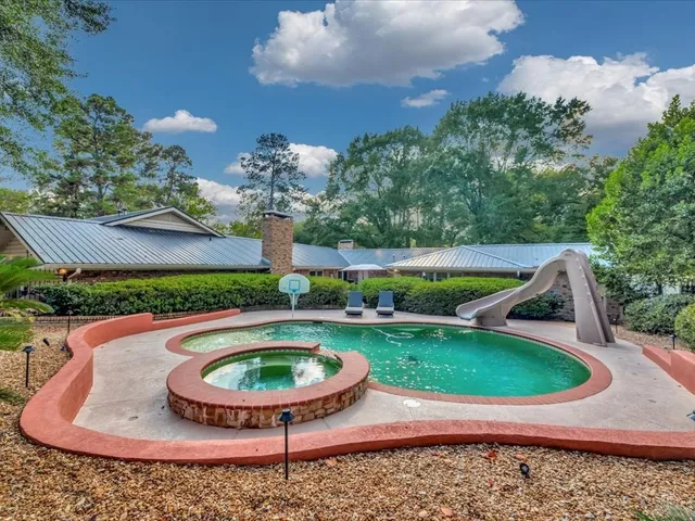 a view of a swimming pool with a yard
