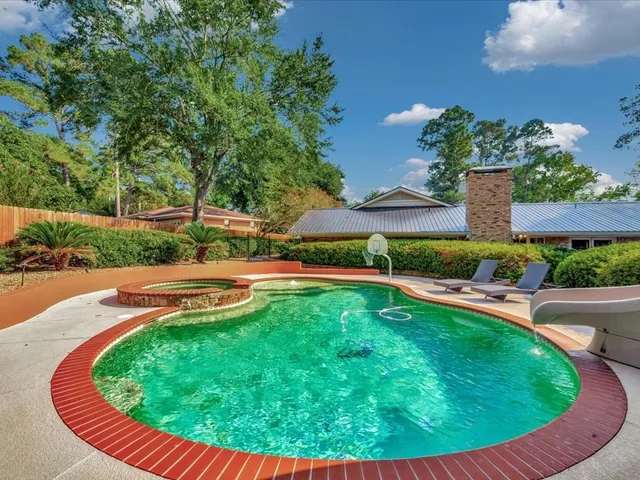 a view of a swimming pool with a yard