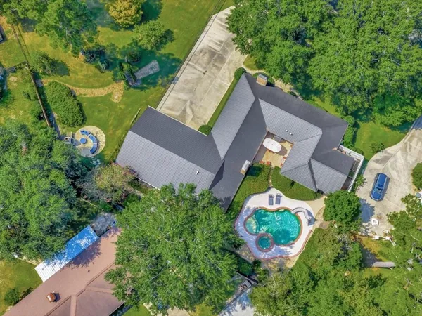 an aerial view of a house with a yard and garden