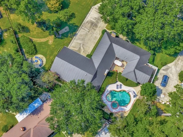 an aerial view of a house with a yard and garden