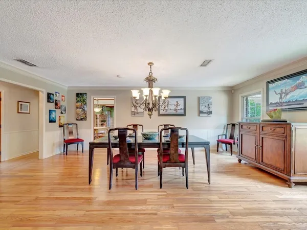 a view of a dining room with furniture and chandelier