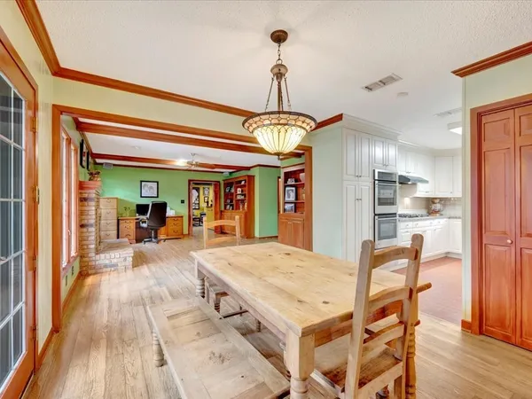 a view of a dining room with furniture window and wooden floor