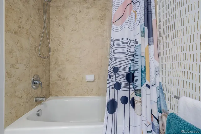 a bathroom with a bathtub and shower