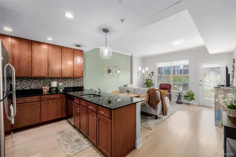 a kitchen with stainless steel appliances granite countertop sink stove and refrigerator