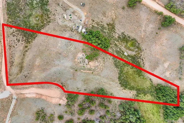 a white and red umbrella sitting on a wooden fence