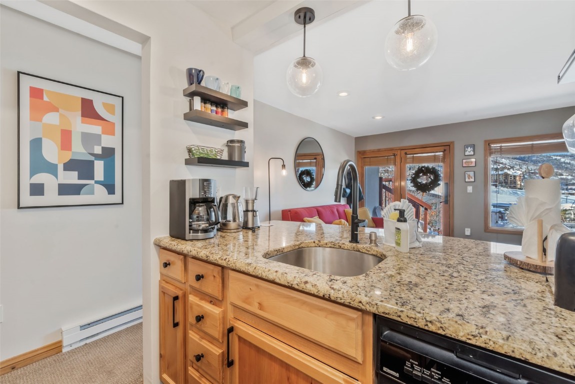 1800 Burgess Creek Road, Unit 205 Steamboat Springs, CO 80487 - Photo 15 of 37 a kitchen with granite countertop stainless steel appliances sink and wooden floor
