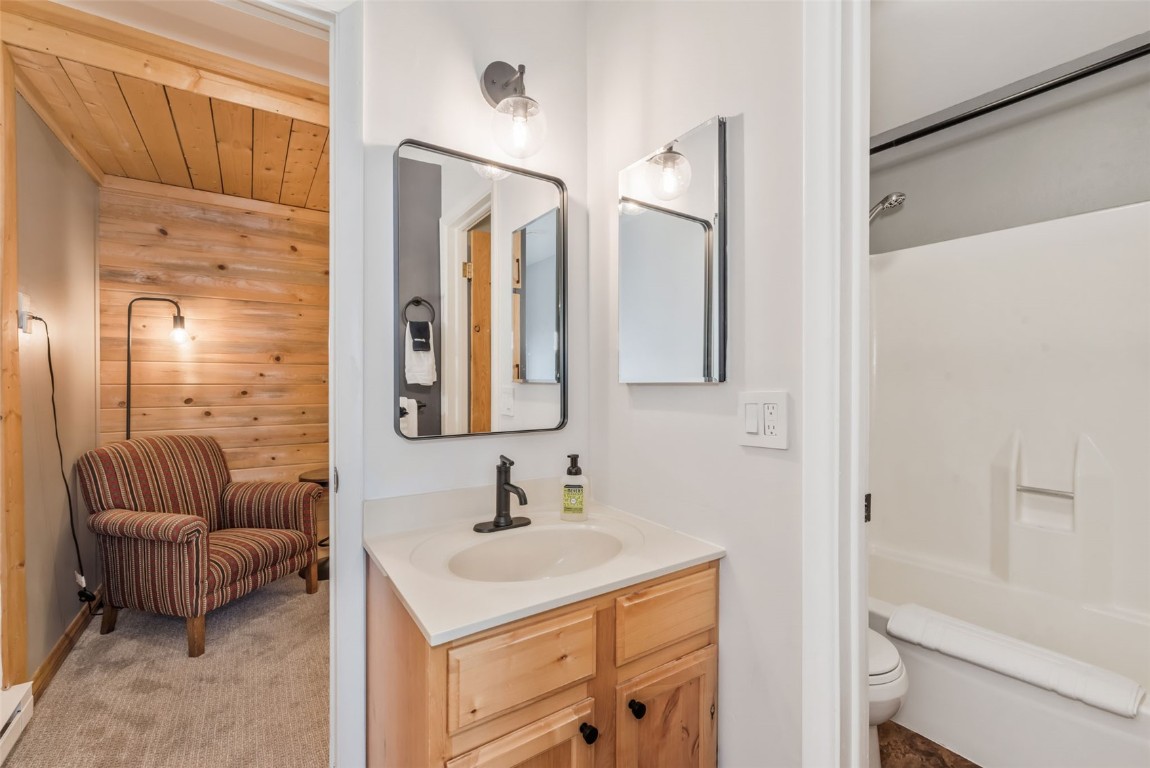 1800 Burgess Creek Road, Unit 205 Steamboat Springs, CO 80487 - Photo 21 of 37 a bathroom with a sink double vanity granite tub shower and a mirror