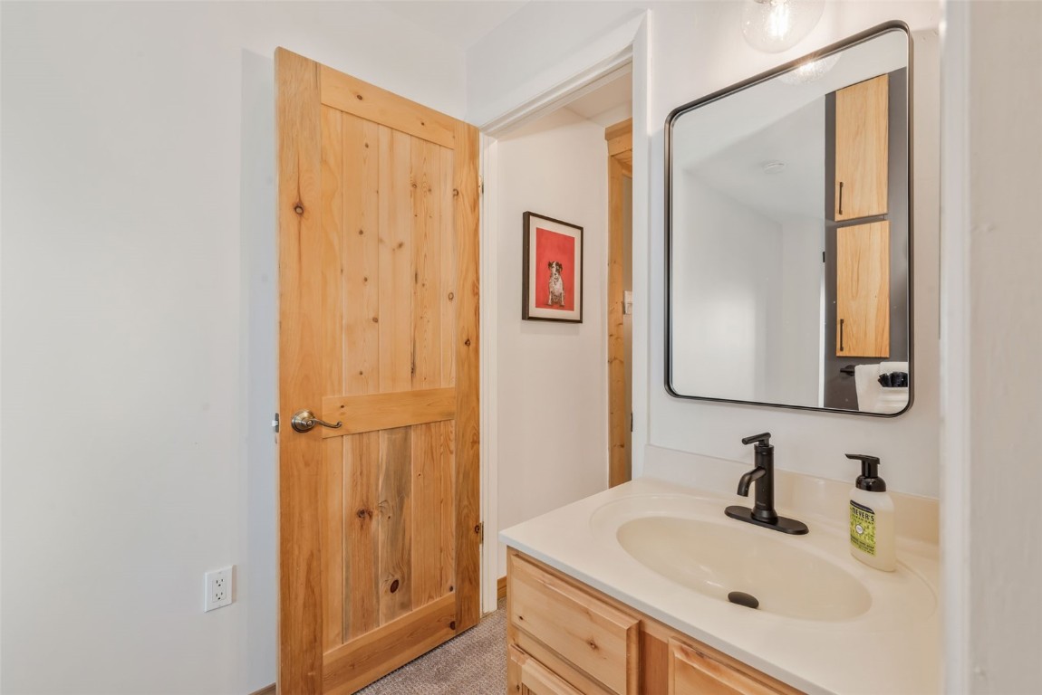 1800 Burgess Creek Road, Unit 205 Steamboat Springs, CO 80487 - Photo 23 of 37 a bathroom with a sink and a mirror