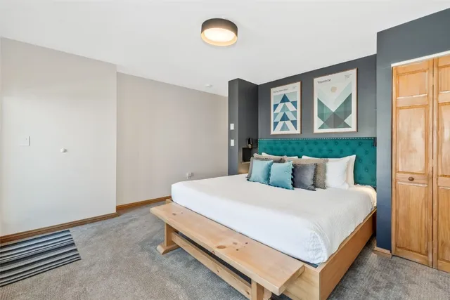 a bedroom with a bed and glass window