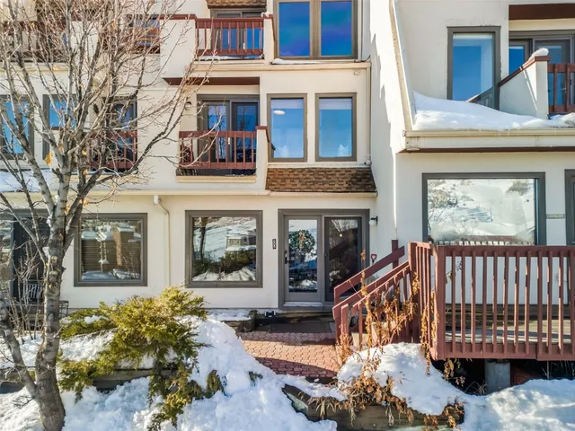 a view of a house with a big yard plants and large trees
