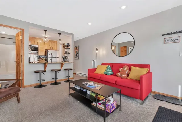 a living room with furniture a window and a potted plant
