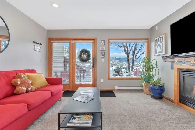 a living room with furniture fireplace and a flat screen tv