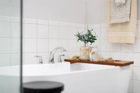 a bathroom with a double vanity sink and a mirror