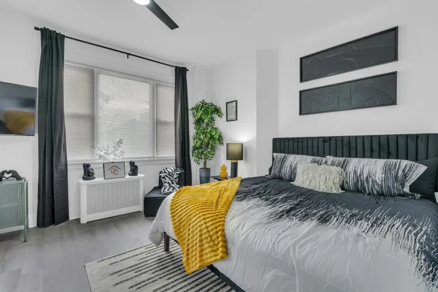 a bedroom with a bed and a large window