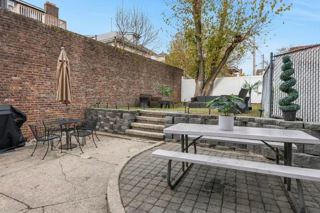 a view of a patio with table and chairs and potted plants