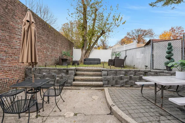 a view of backyard with sitting area