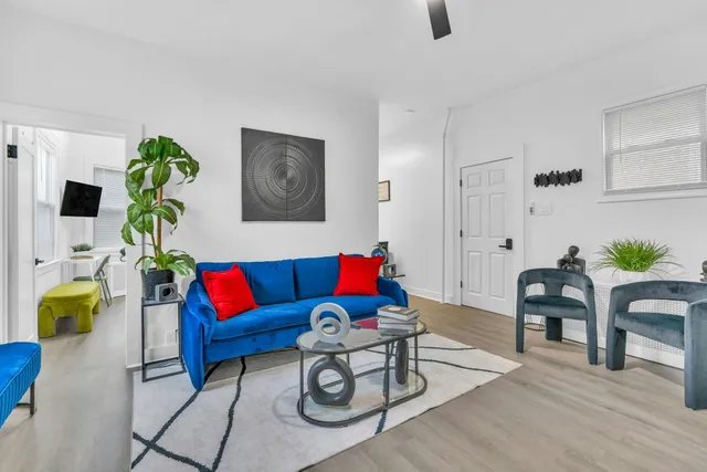 a living room with furniture and wooden floor