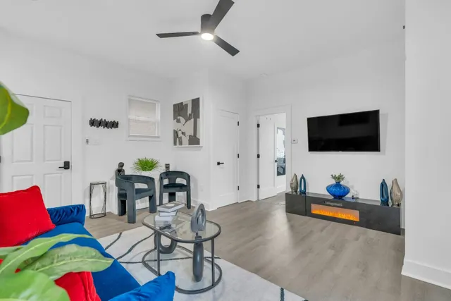 a living room with furniture and a flat screen tv