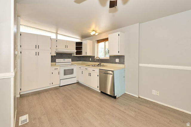 669 Colonial Avenue Layton, UT 84041 - Photo 6 of 51 White cabinetry, wood-finish flooring, stainless steel dishwasher, tile backsplash, and overhead lighting fixture