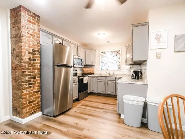 a kitchen with a refrigerator a sink and dishwasher
