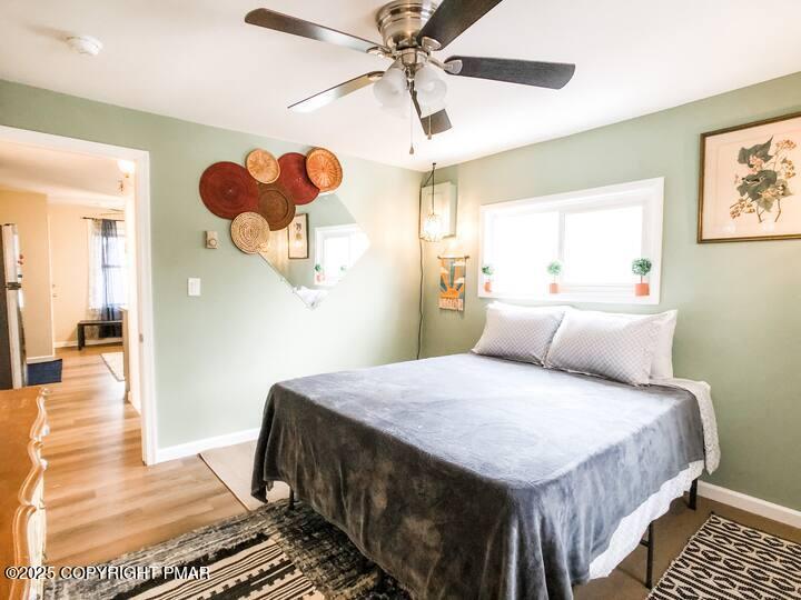 36 Main Street Delaware Water Gap, PA 18327 - Photo 20 of 37 a bedroom with a bed and a chandelier