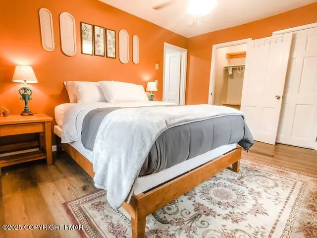 a bed sitting in a bedroom next to a window