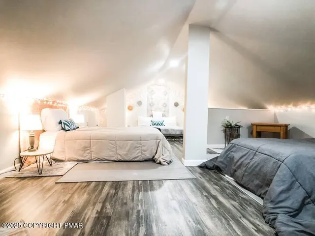 a bedroom with a large bed and a night stand