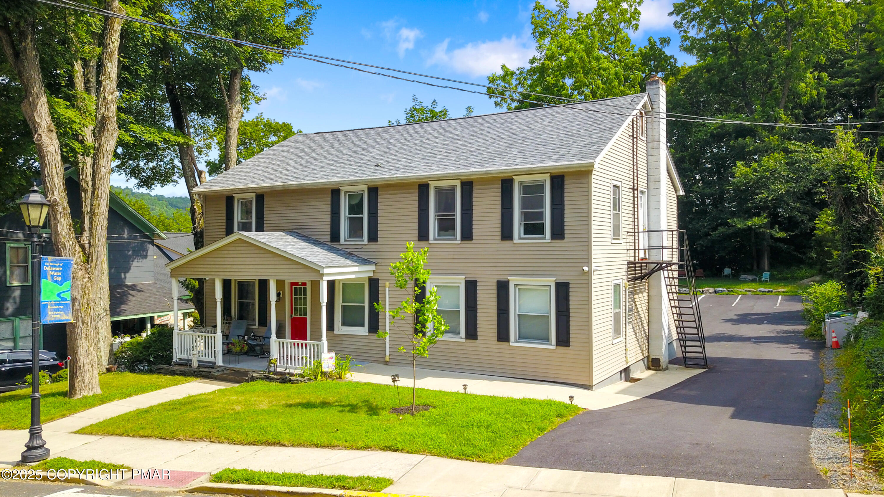 36 Main Street Delaware Water Gap, PA 18327 - Photo 4 of 37 a front view of a house with a yard table and chairs