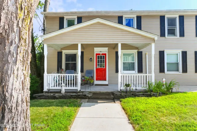 a front view of a house with garden