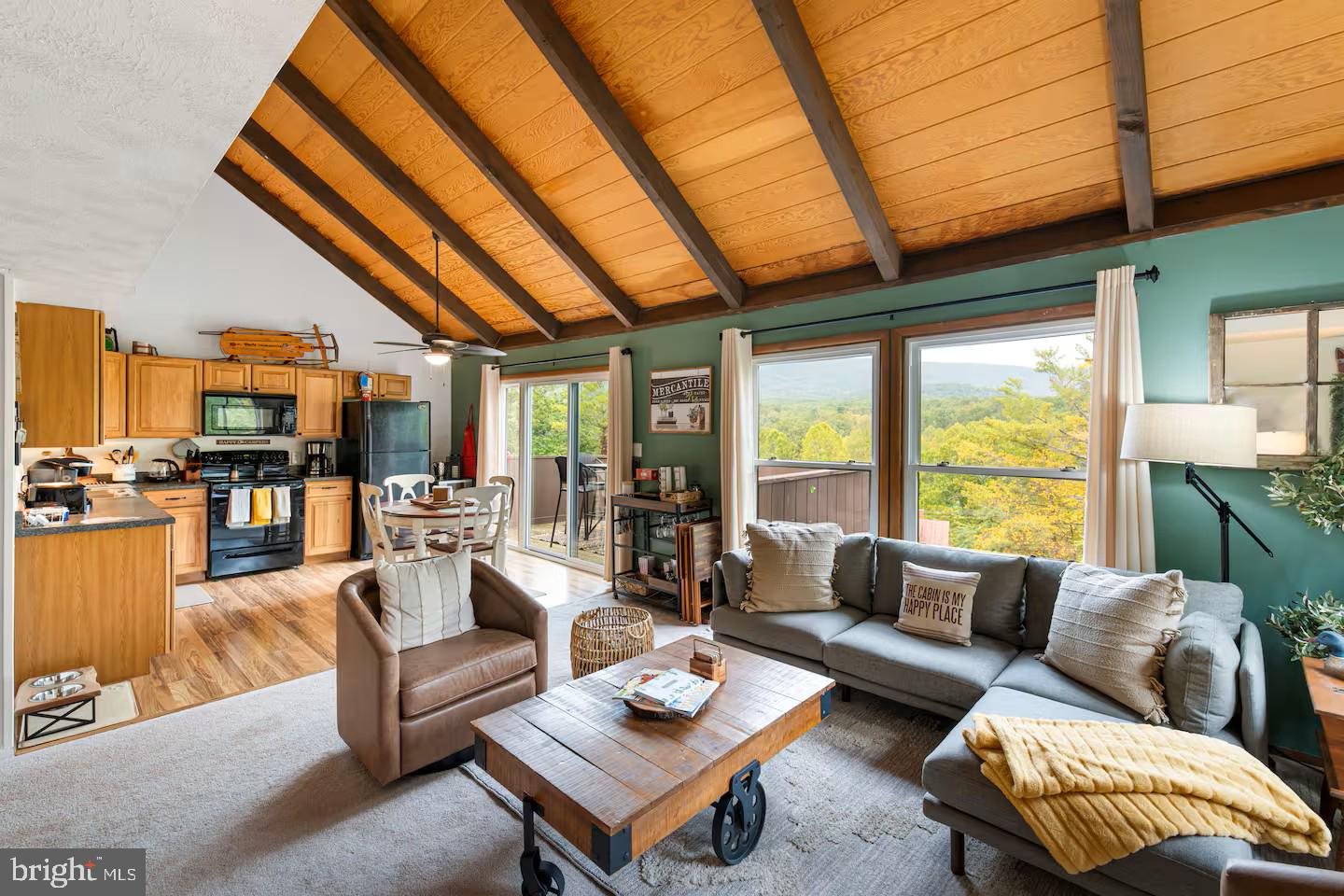 248 The Hill Road Basye, VA 22810 - Photo 6 of 21 a living room with furniture a rug kitchen view and a large window