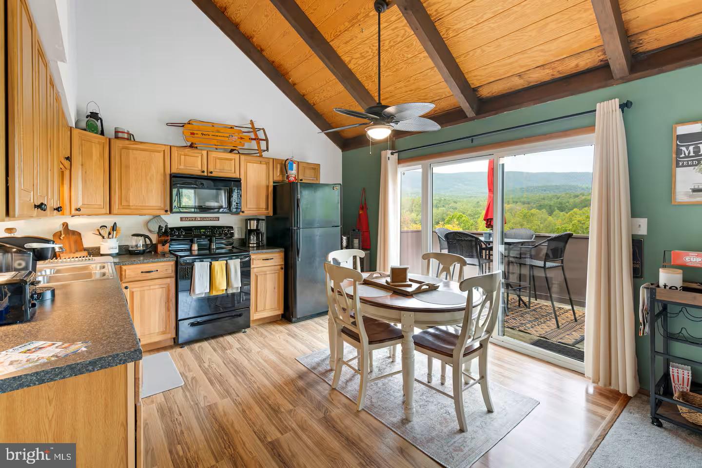248 The Hill Road Basye, VA 22810 - Photo 10 of 21 a view of a dining room with furniture a kitchen view and a large window