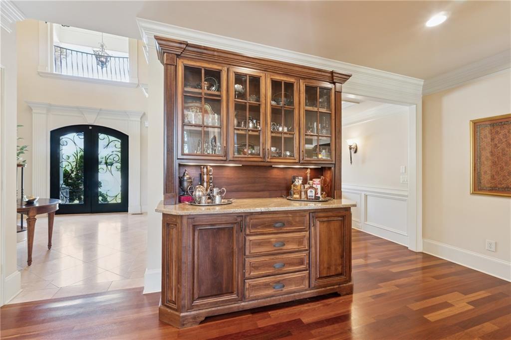 6935 Wakehurst Place Cumming, GA 30040 - Photo 28 of 92 a view of kitchen with stainless steel appliances granite countertop a stove and a wooden floors